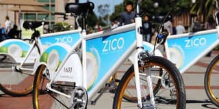 A group of bikes with ads on them

ads on bikes