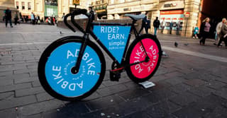 A bike with advertisements on the wheels

ads on bikes