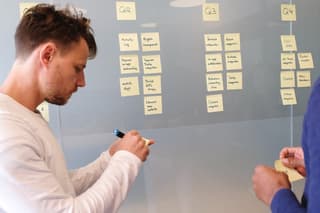 Two people planning with post-it notes